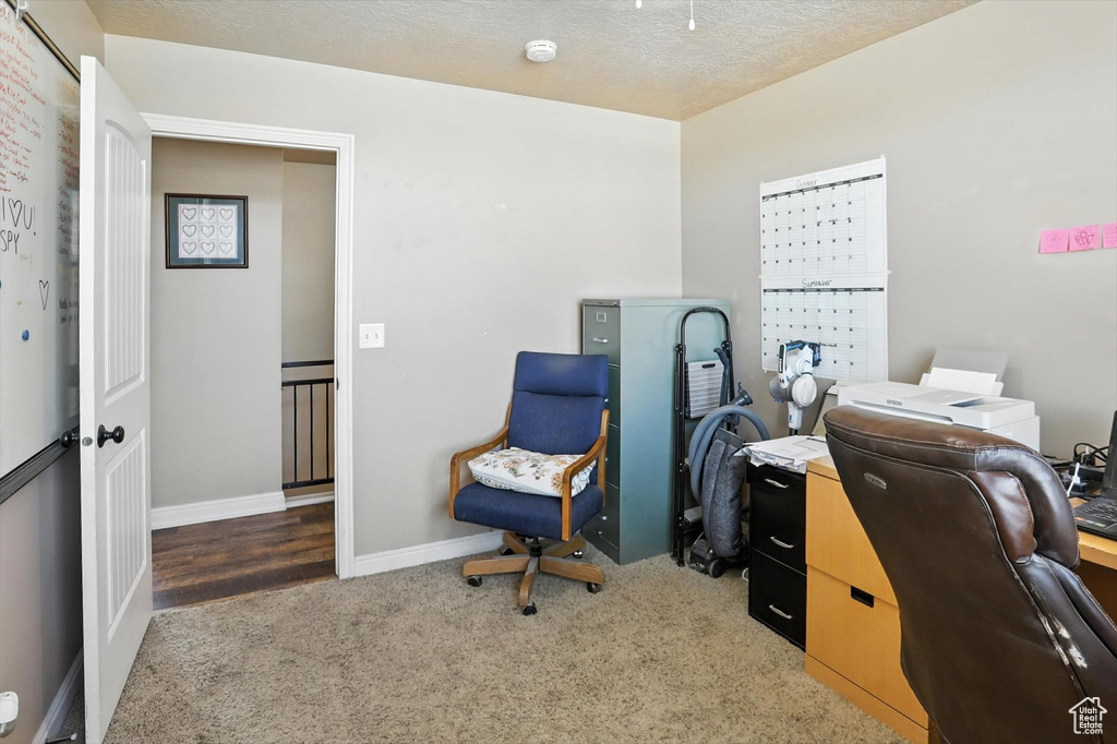 Carpeted office featuring baseboards