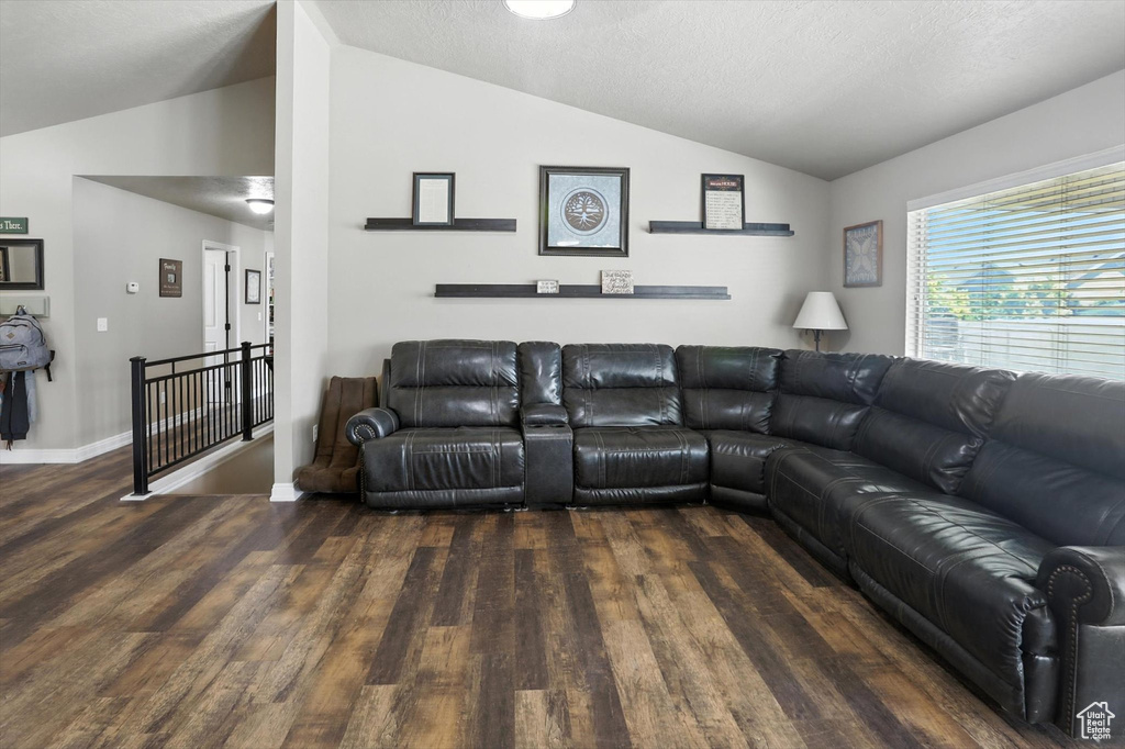 Living room with lofted ceiling and wood finished floors