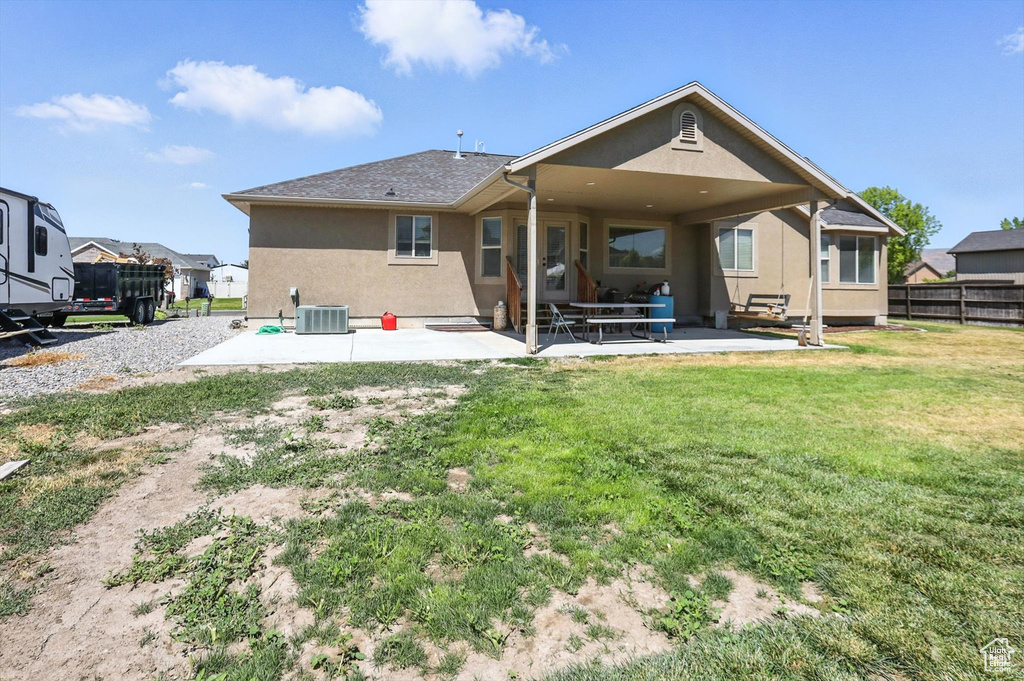 Back of property with stucco siding and a patio area