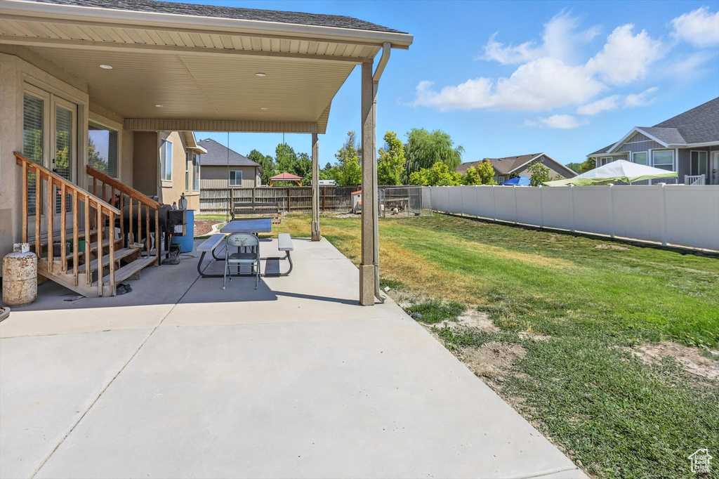 Fenced backyard with a patio area and a residential view