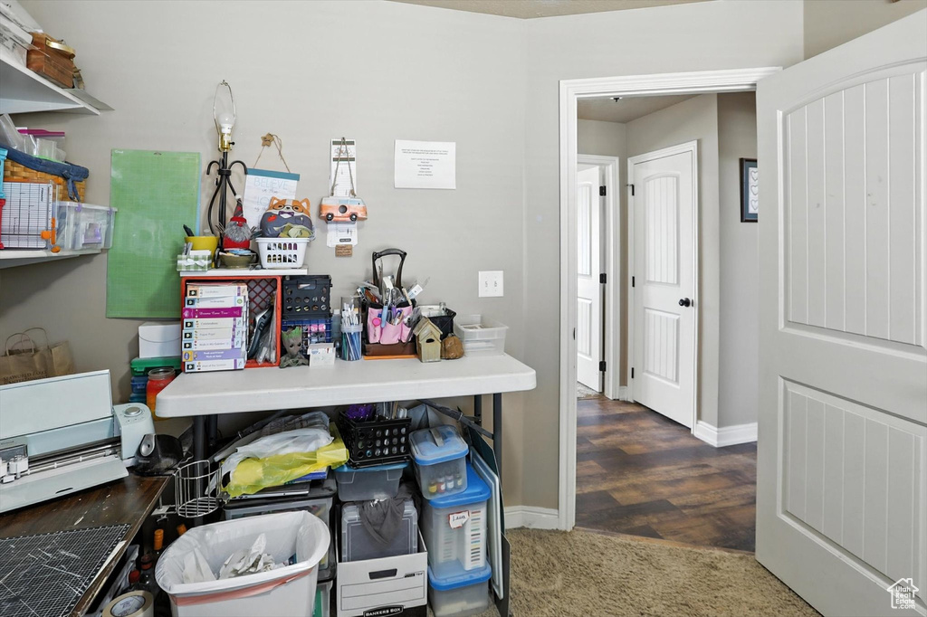 Office space featuring baseboards and wood finished floors