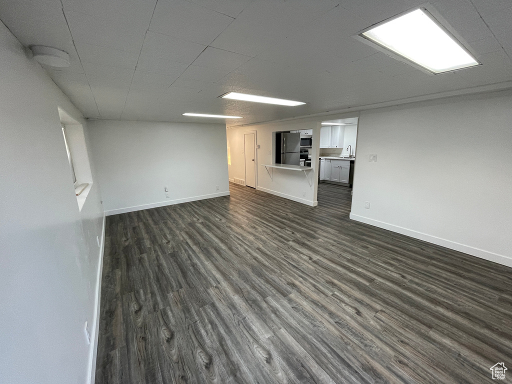 Unfurnished living room featuring dark wood finished floors