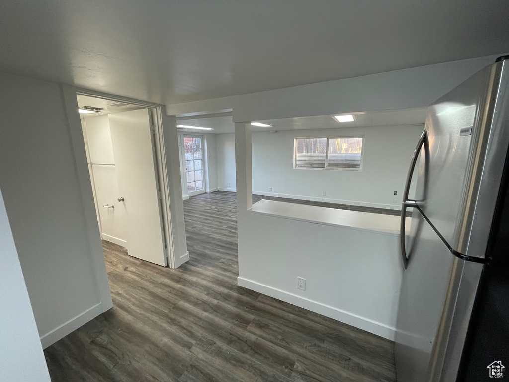 Kitchen featuring freestanding refrigerator and dark wood-style flooring