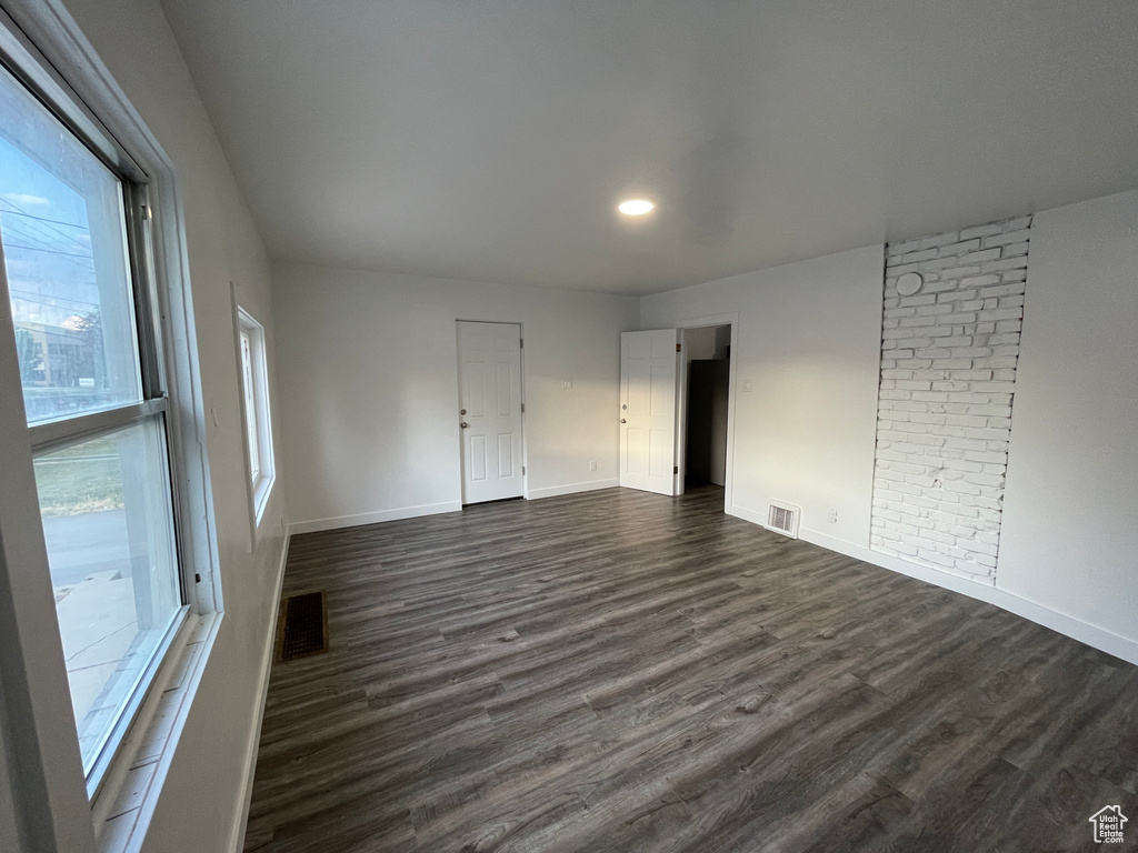 Spare room featuring dark wood finished floors and recessed lighting