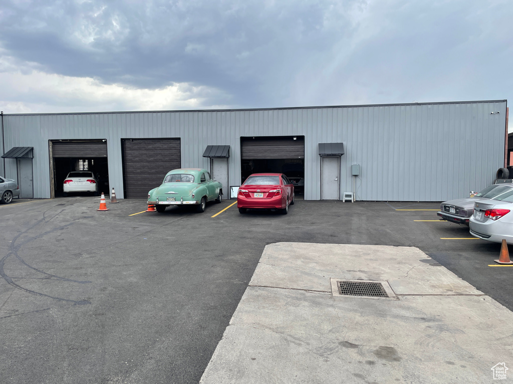 View of vehicle parking with a detached garage