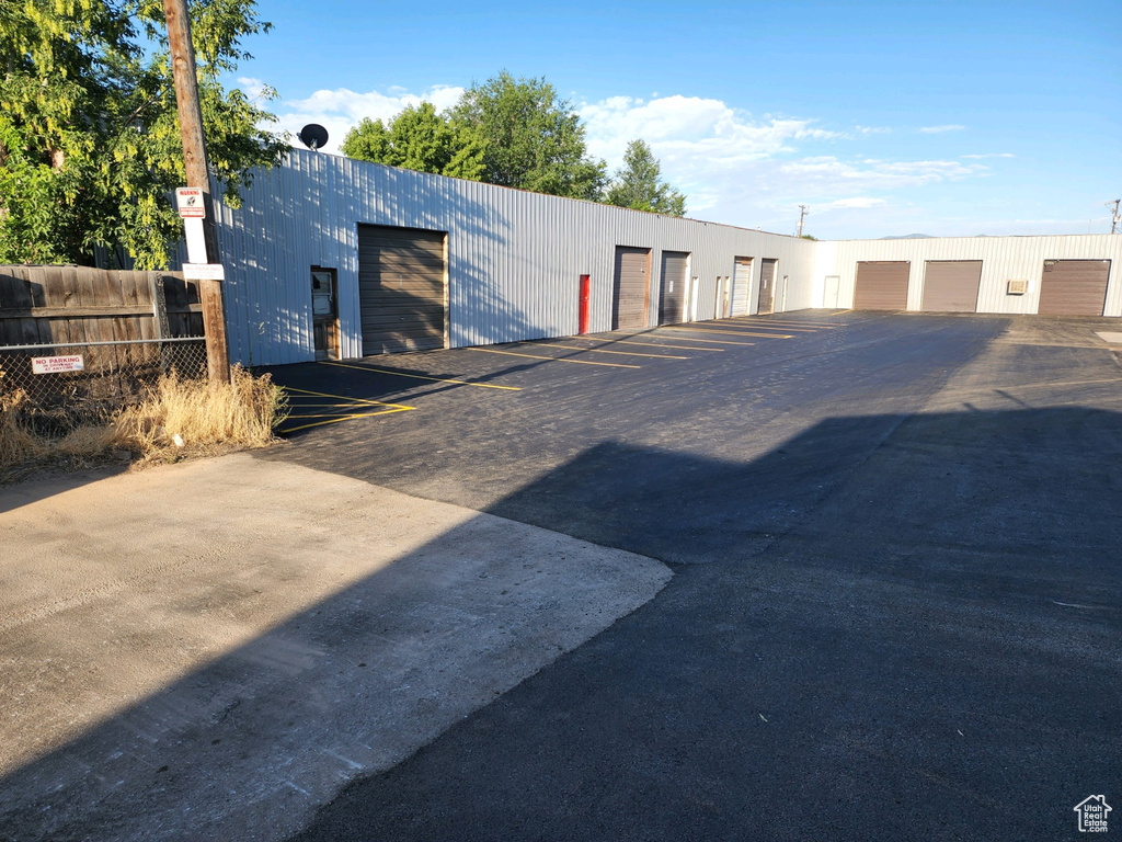 View of outbuilding featuring community garages