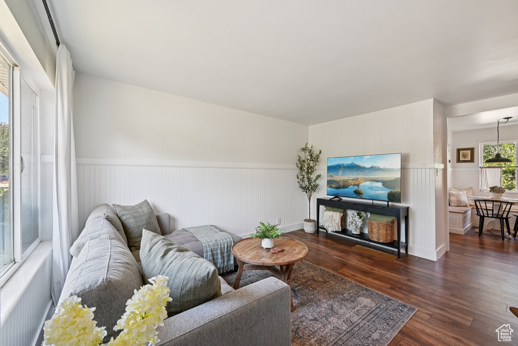 Living room with wainscoting and dark wood finished floors