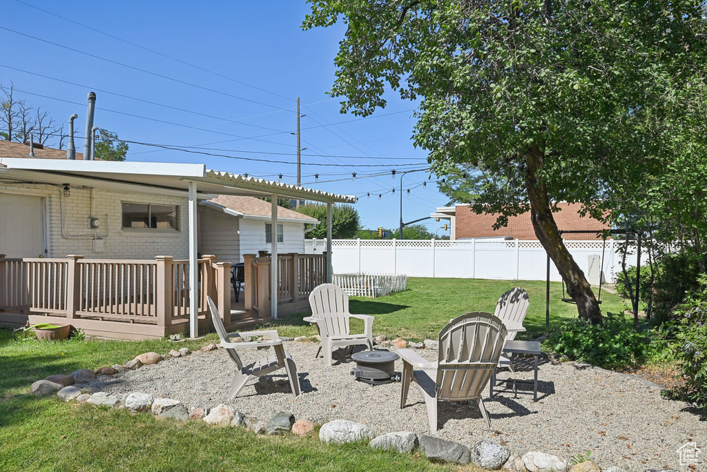 View of yard with a fire pit, a patio area, and a wooden deck