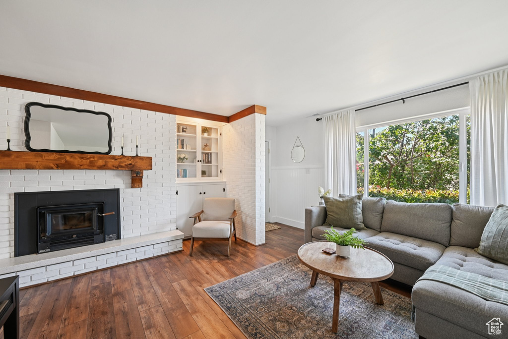 Living area with hardwood / wood-style floors and a fireplace
