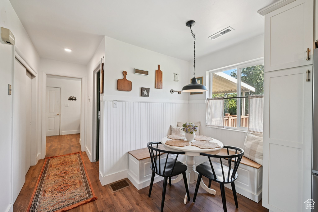 Dining space featuring breakfast area, wood finished floors, a wainscoted wall, and recessed lighting