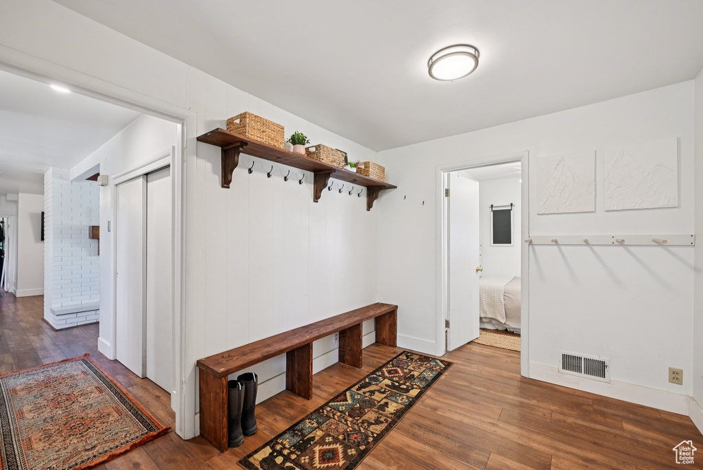 Mudroom featuring hardwood / wood-style floors and baseboards