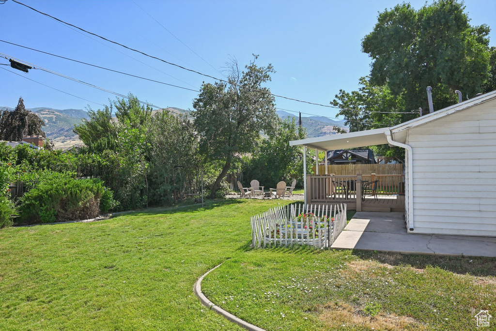 View of yard with a mountain view and a patio area