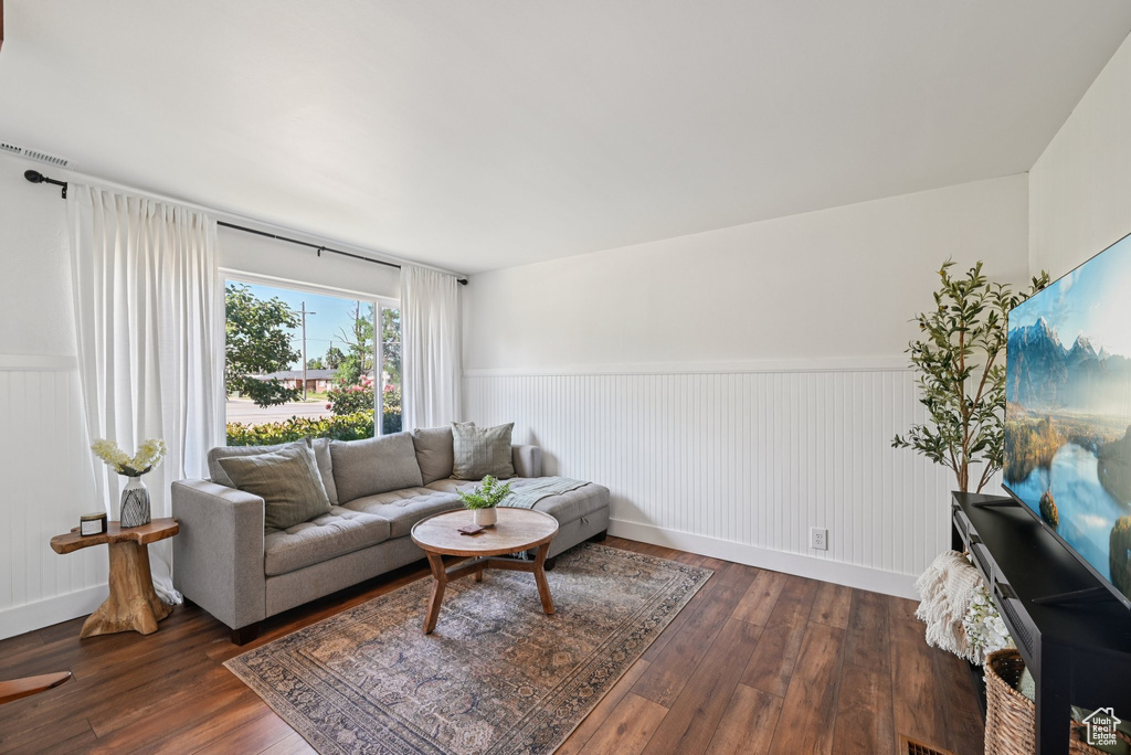 Living area featuring a wainscoted wall and hardwood / wood-style flooring