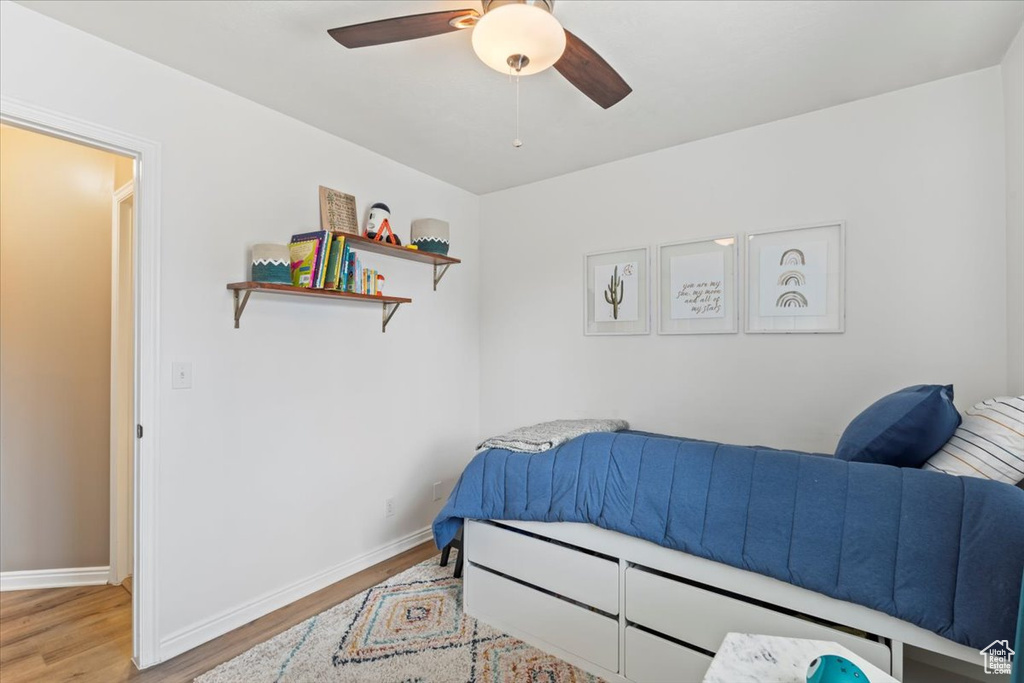 Bedroom with wood finished floors and ceiling fan