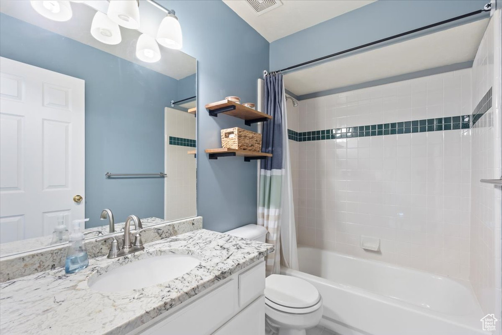 Bathroom with shower / bath combo and vanity