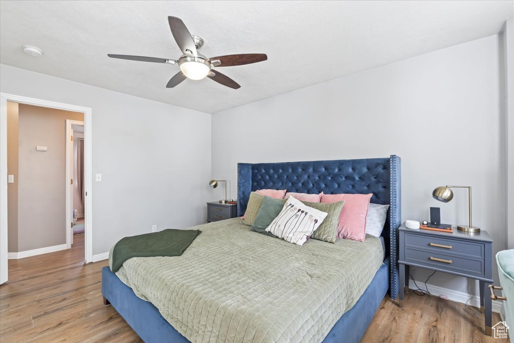 Bedroom featuring wood finished floors and a ceiling fan
