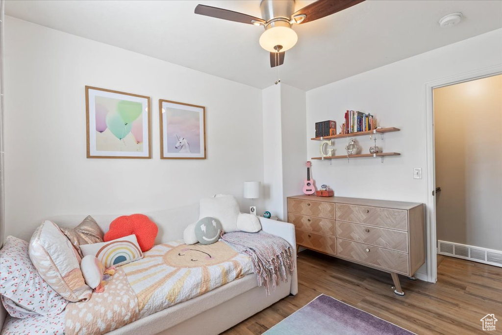 Bedroom with wood finished floors and a ceiling fan