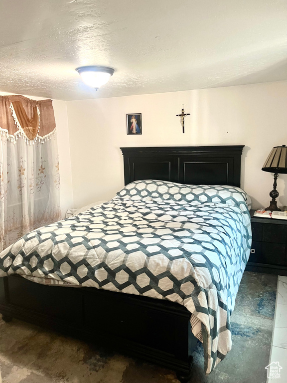Bedroom featuring a textured ceiling