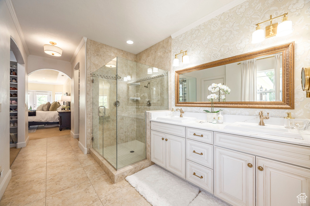 Full bathroom with crown molding, double vanity, a stall shower, tile patterned floors, and connected bathroom