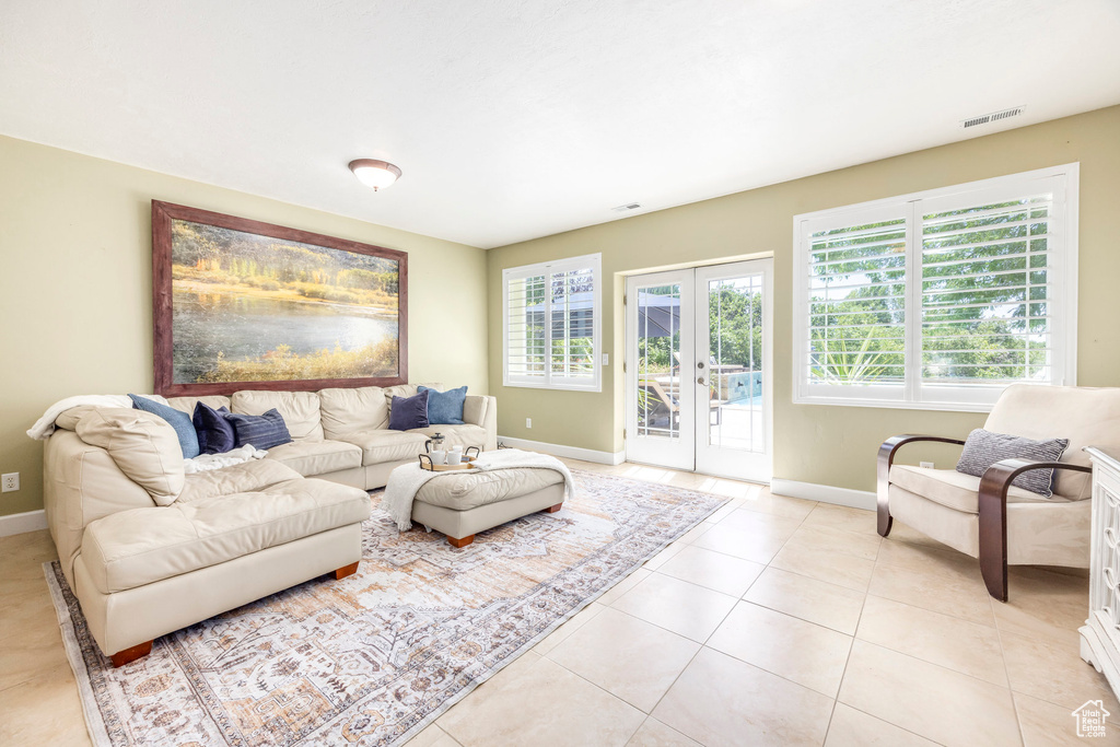 Living room featuring light tile patterned floors and french doors