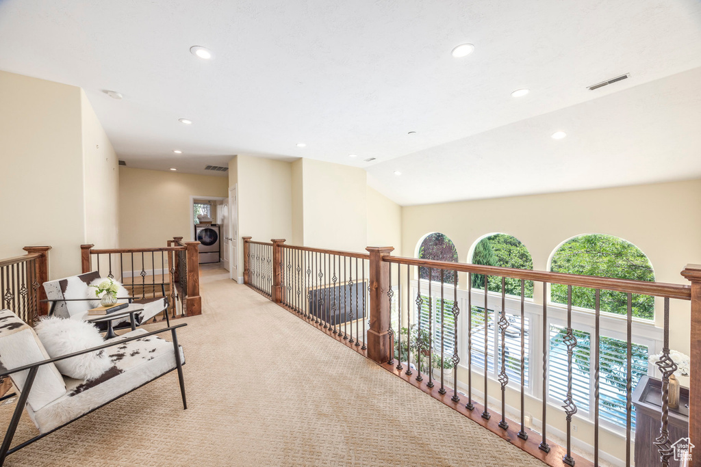 Hall with washer / clothes dryer, recessed lighting, light colored carpet, and an upstairs landing