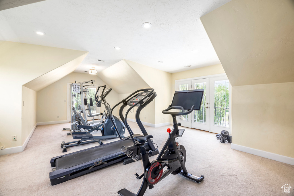 Exercise area with lofted ceiling, recessed lighting, and carpet