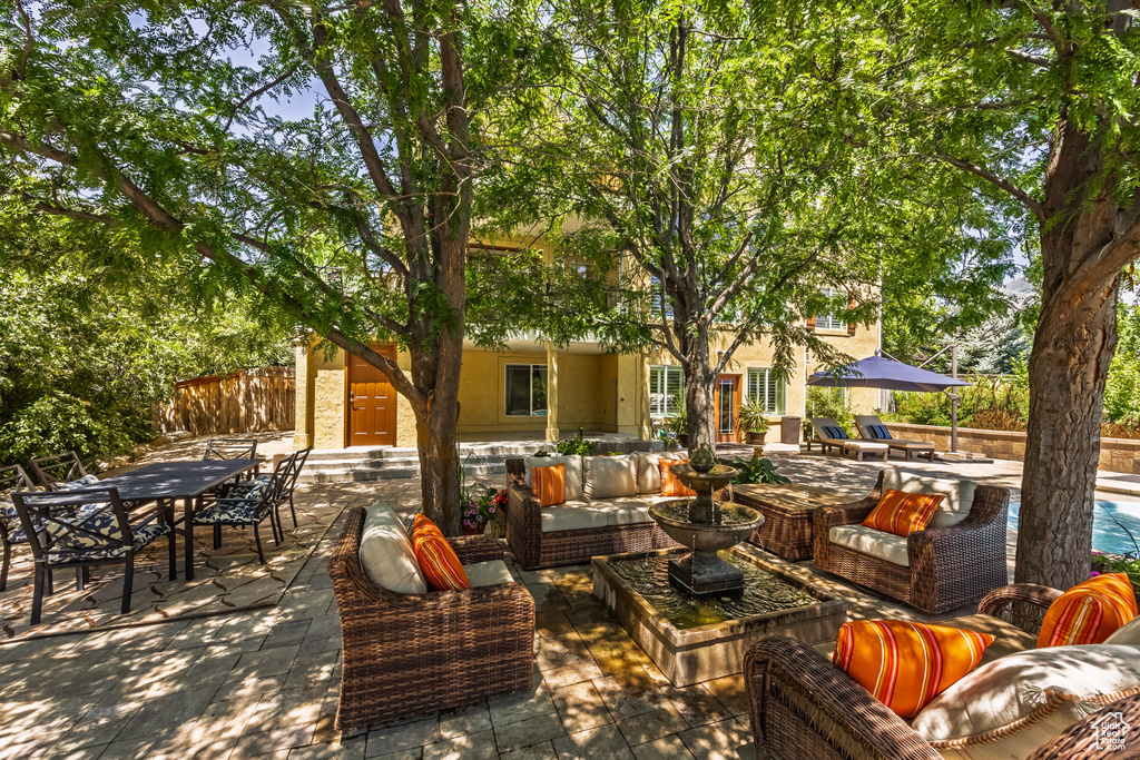 View of patio / terrace with an outdoor living space, outdoor dining area, and a swimming pool