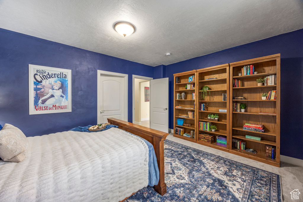 Bedroom with carpet floors and a textured ceiling