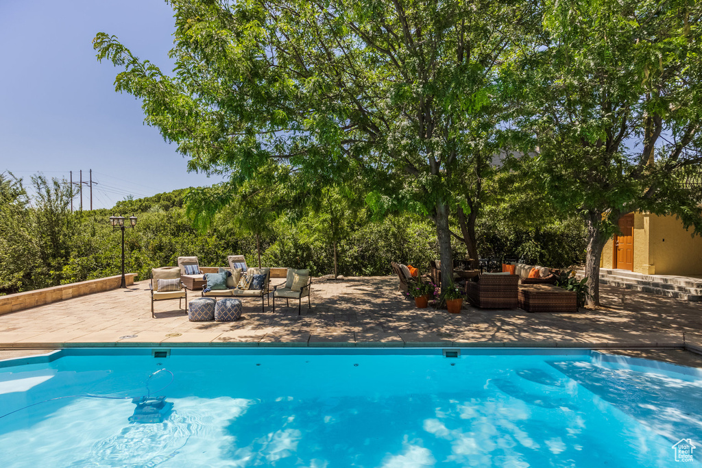 Swimming pool featuring an outdoor hangout area and a patio