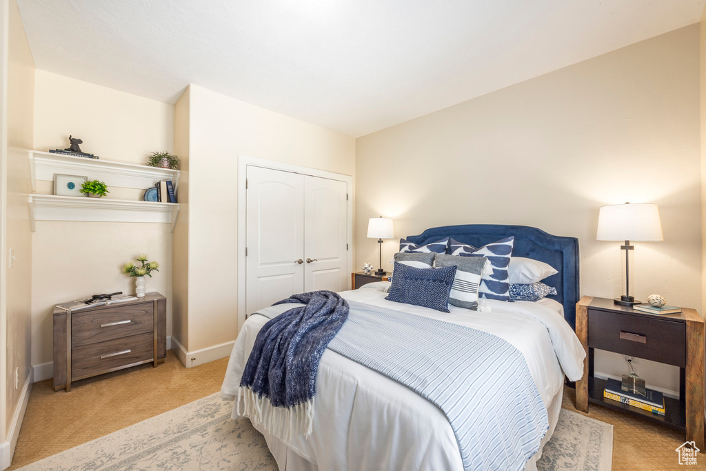Bedroom featuring carpet flooring and a closet