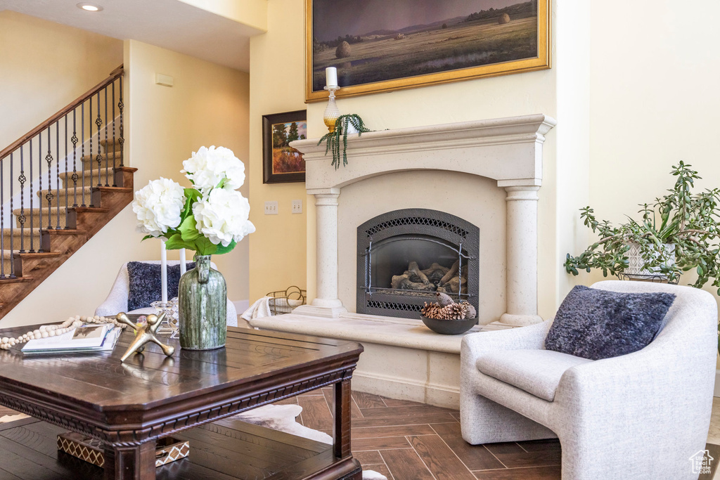 Living area with stairs, recessed lighting, and a glass covered fireplace