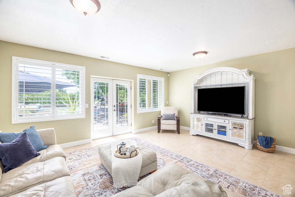 Living area featuring tile patterned floors and french doors