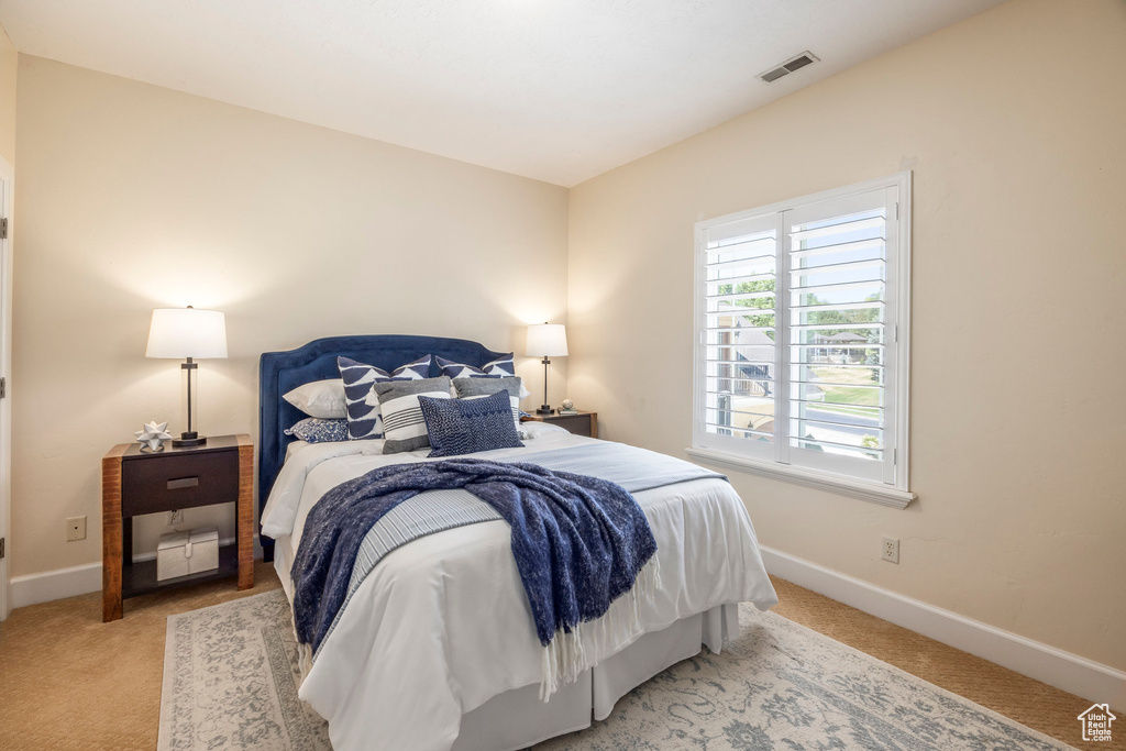 Carpeted bedroom featuring baseboards