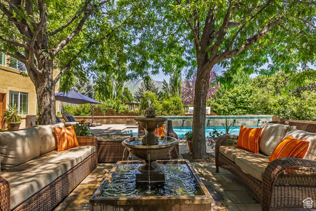 View of patio with an outdoor hangout area and a mountain view