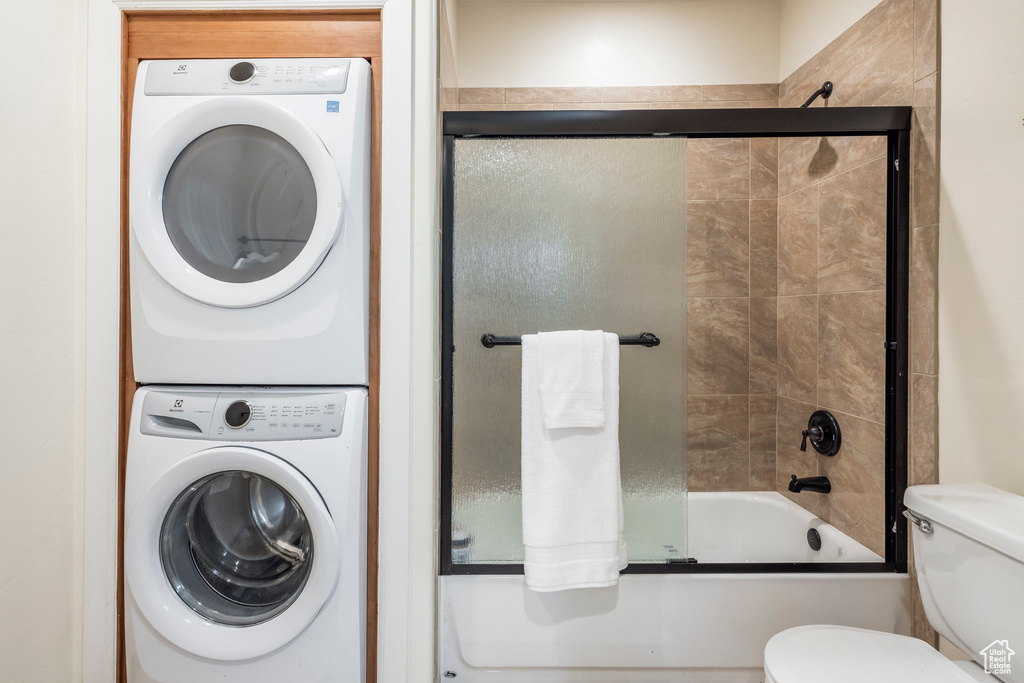 Laundry room with stacked washing machine and dryer