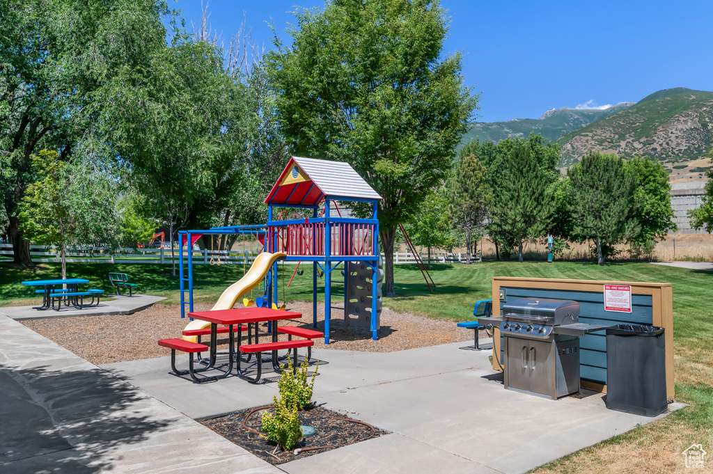Community jungle gym featuring a yard and a mountain view