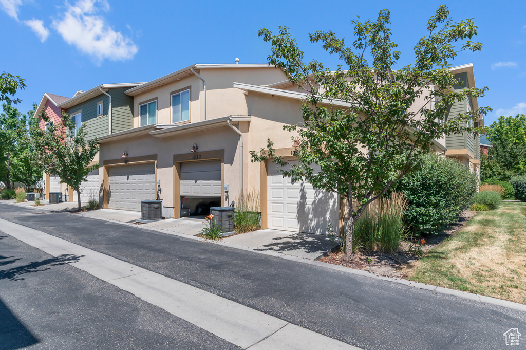 View of property with stucco siding and an attached garage