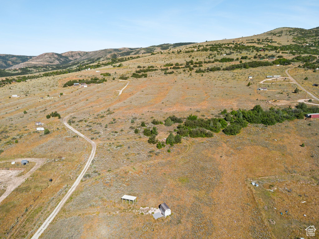 Aerial view of property and surrounding area with a mountainous background and rural landscape