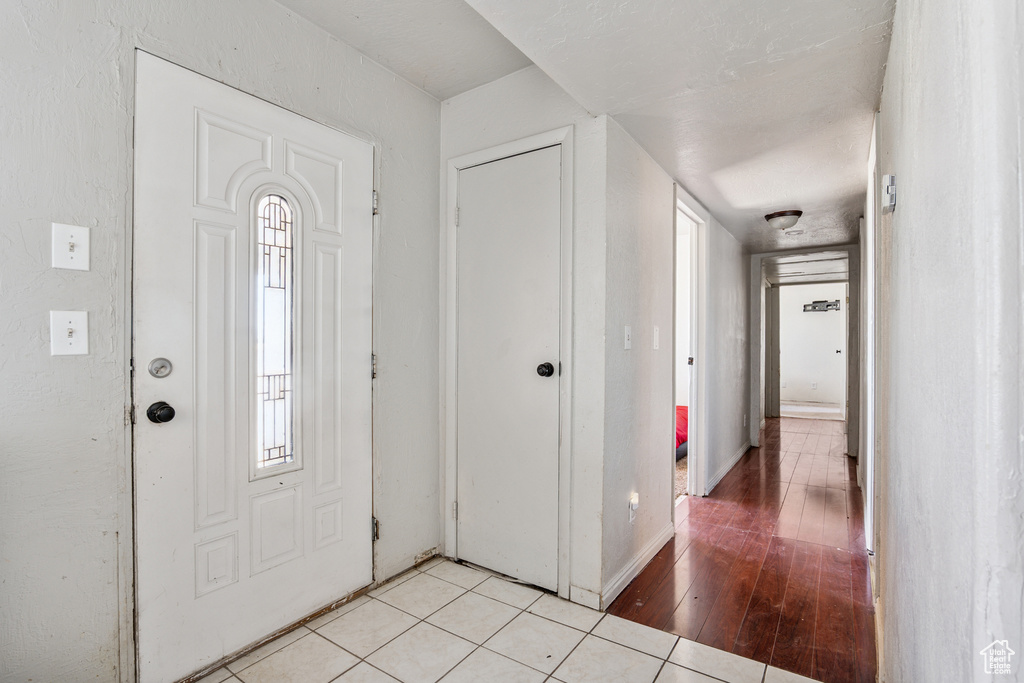Entrance foyer with light tile patterned flooring and plenty of natural light