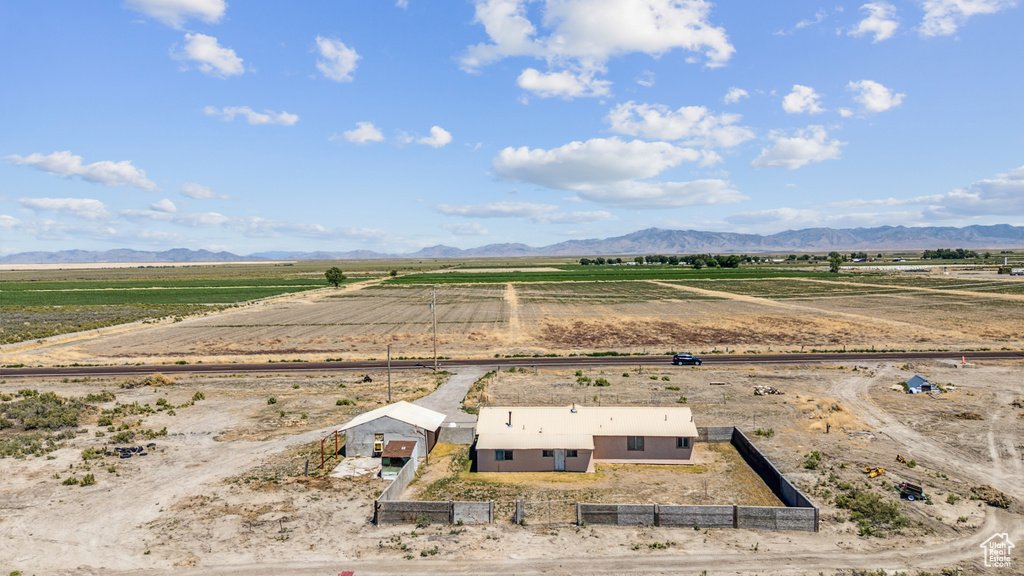 Aerial view of sparsely populated area featuring a mountain backdrop and farmland