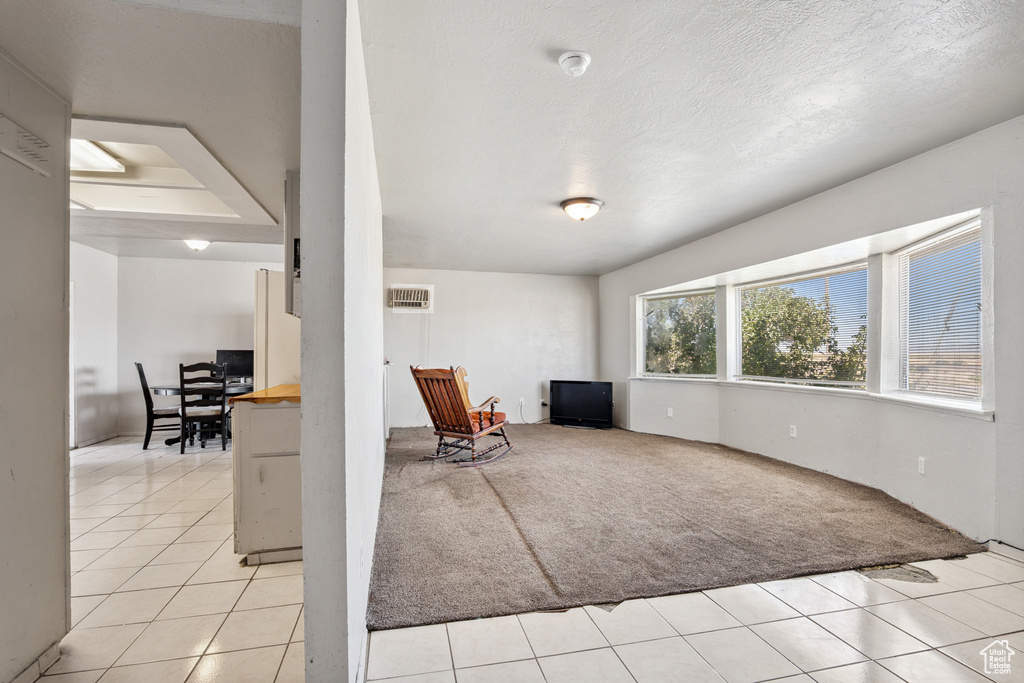 Unfurnished room with light colored carpet and light tile patterned floors