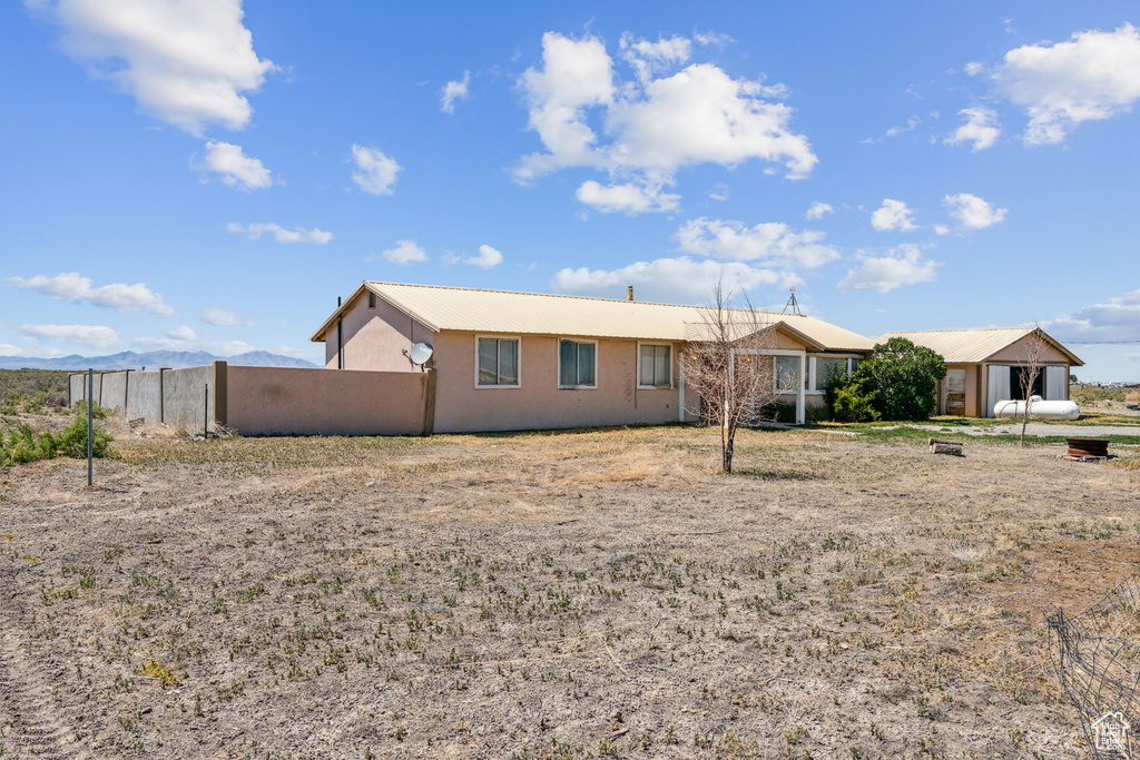 View of front of home with a metal roof and stucco siding