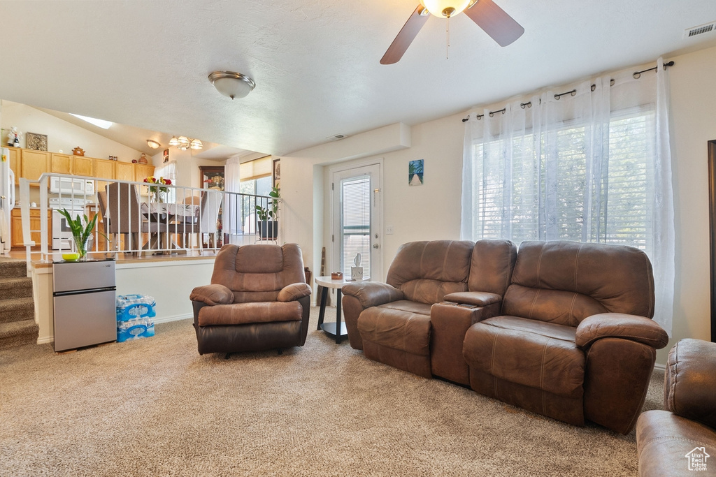 Living room with carpet flooring and a ceiling fan