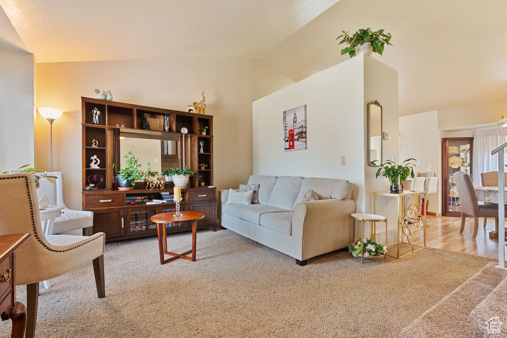 Living room featuring lofted ceiling and light carpet