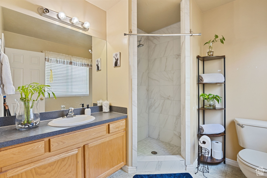 Bathroom featuring vanity and tiled shower