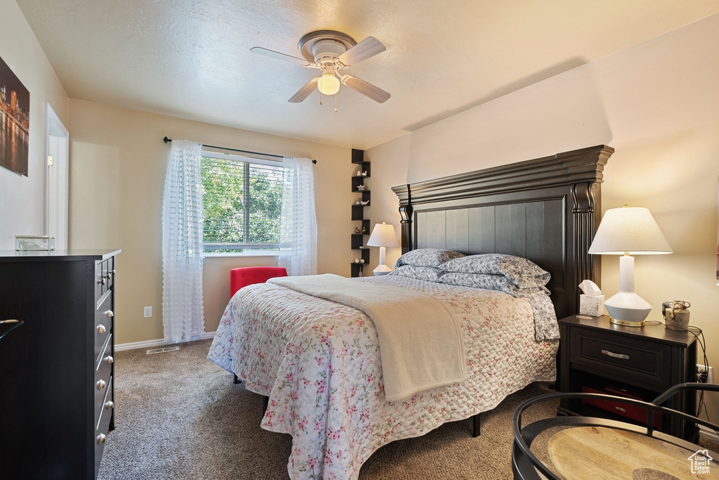 Bedroom with carpet floors and a ceiling fan