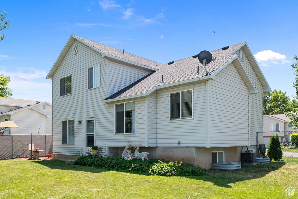 Rear view of house with roof with shingles