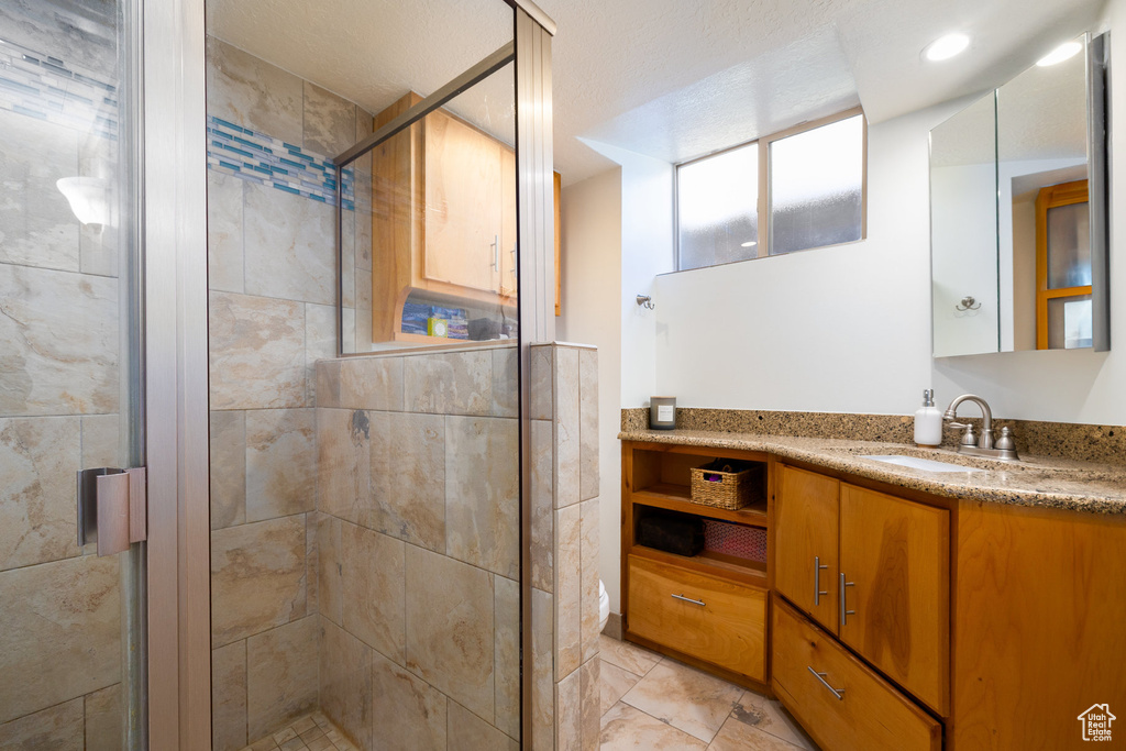 Bathroom featuring vanity and a shower stall