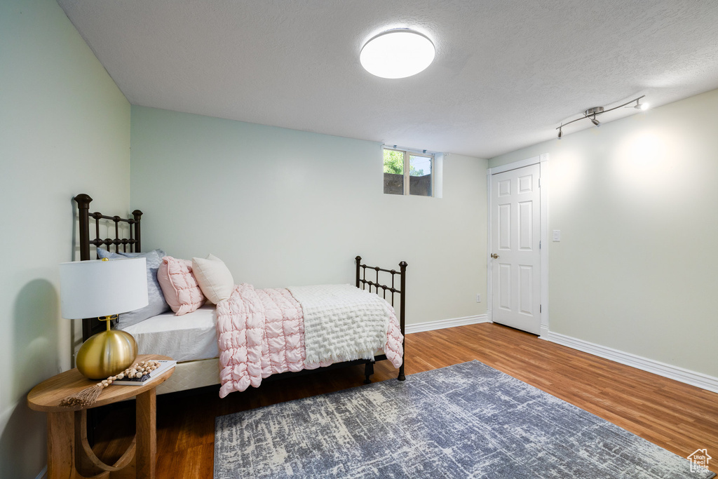 Bedroom featuring wood finished floors and baseboards