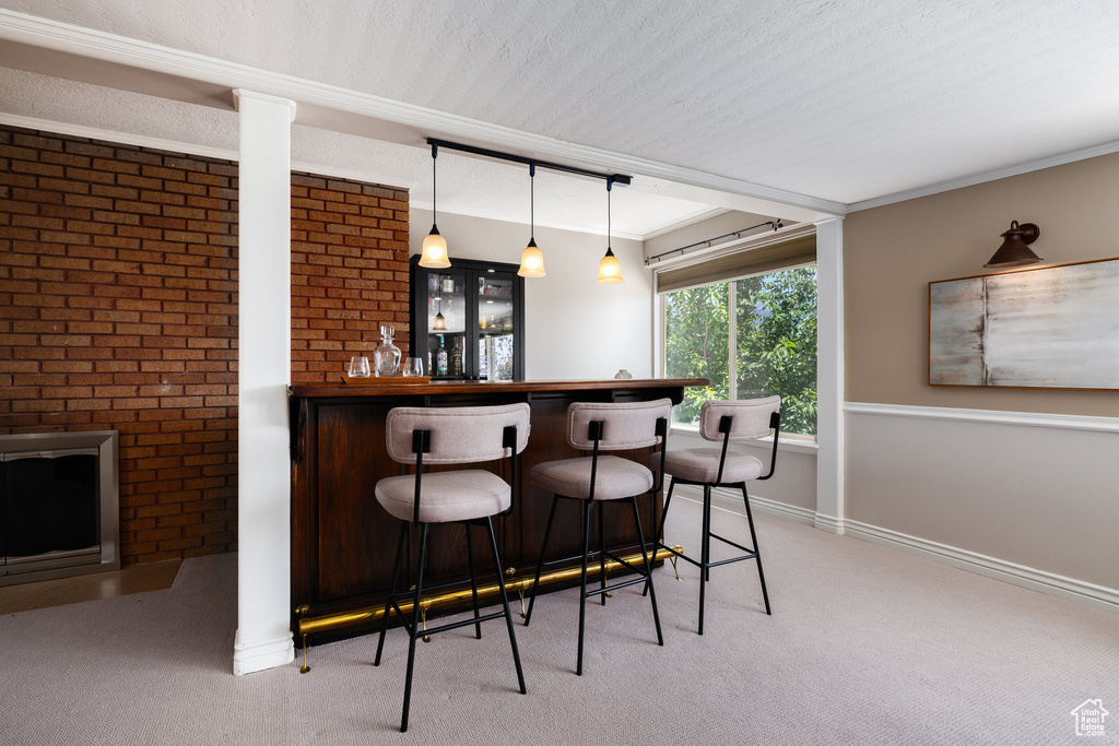 Indoor dry bar with light colored carpet and decorative light fixtures